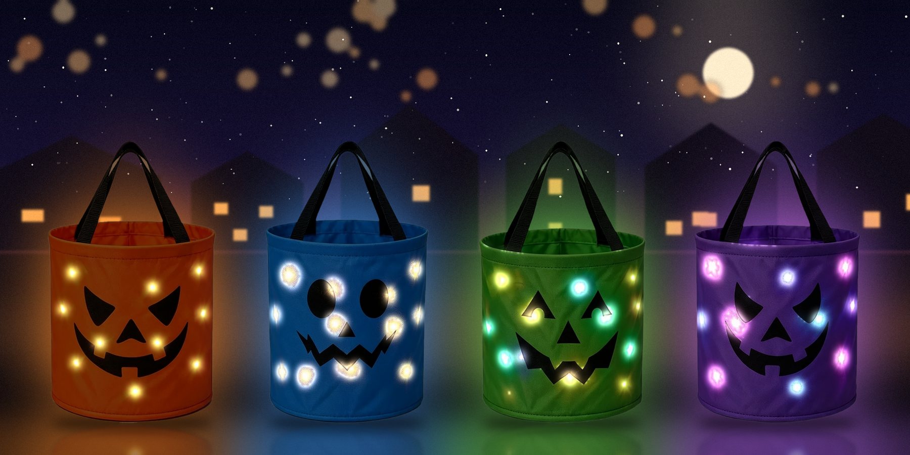 Four glowing pumpkin buckets at night